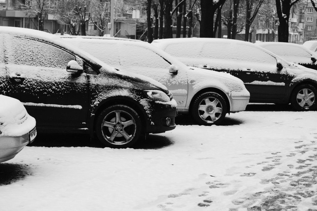 black suv on snow covered ground during daytime